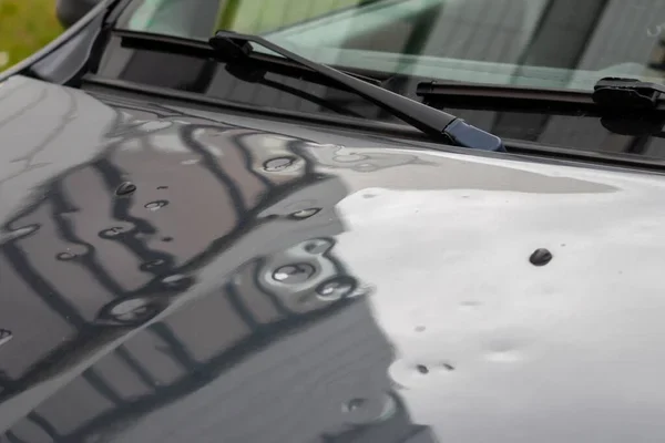 depositphotos_458812666-stock-photo-car-engine-hood-many-hail